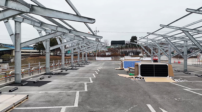 Durable 300KW carbon steel solar carport installation in Korea, providing eco-friendly energy, vehicle protection, and space-saving design for efficient solar power generation